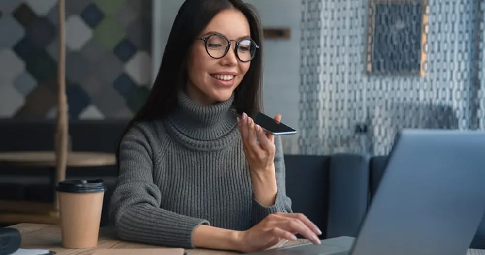 business woman voice mailing while facing her laptop 1