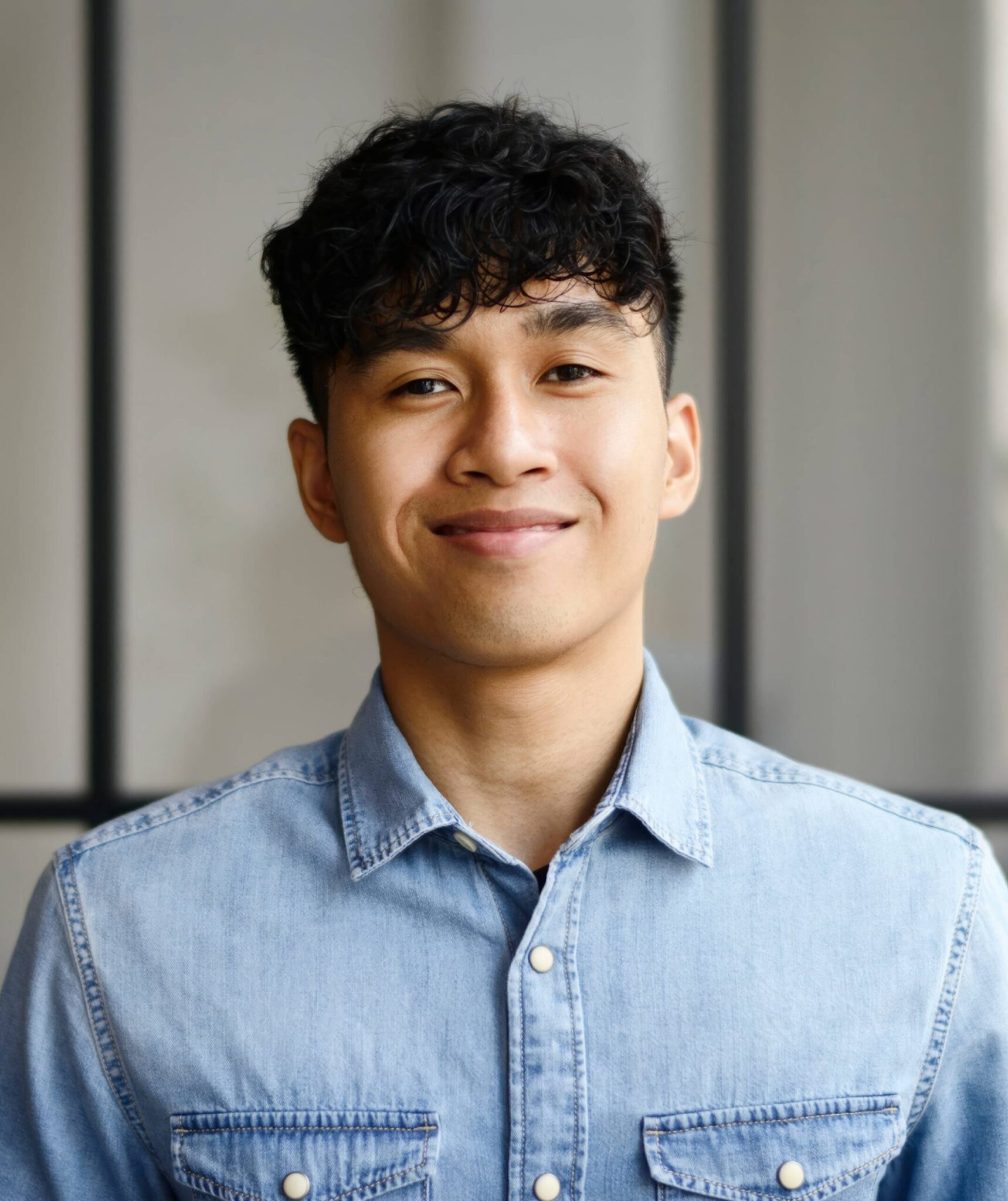 man smiling wearing blue polo
